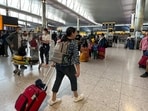 Travelers at Heathrow Airport in London. Travelers at Heathrow Airport in London.