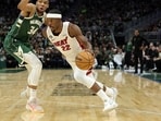 Jimmy Butler #22 of the Miami Heat drives around Giannis Antetokounmpo #34 of the Milwaukee Bucks during the second half of Game 5 of the Eastern Conference First Round Playoffs at Fiserv Forum.