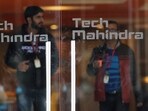 Employees walk outside the cafeteria in the Tech Mahindra office building in Noida on the outskirts of New Delhi.