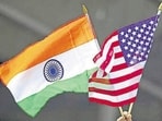 A man holds the flags of India and the US. A man holds the flags of India and the US.