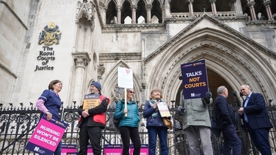 Nurses stand outside the High Court in central London, where the government is bringing a challenge over the planned strike action by the Royal College of Nurses (RCN) in the long-running dispute over pay, in London, Thursday. (AP) Nurses stand outside the High Court in central London, where the government is bringing a challenge over the planned strike action by the Royal College of Nurses (RCN) in the long-running dispute over pay, in London, Thursday. (AP)