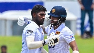 Sri Lanka's Nishan Madushka celebrates with his teammate Kusal Mendis (R) after scoring a double century (200 runs) during fourth day of the second and final cricket Test match between Sri Lanka and Ireland at the Galle International Cricket Stadium in Galle on April 27, 2023. (Photo by Ishara S. KODIKARA / AFP) (AFP)