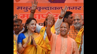 Chief minister Yogi Adityanath with BJP MP Hema Malini during a public meeting in support of BJP candidate ahead of UP Municipal elections, in Mathura on Thursday. (PTI) Chief minister Yogi Adityanath with BJP MP Hema Malini during a public meeting in support of BJP candidate ahead of UP Municipal elections, in Mathura on Thursday. (PTI)