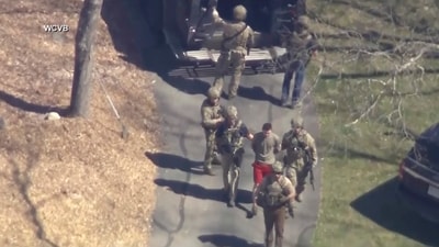 Jack Teixeira, in T-shirt and shorts, being taken into custody by armed tactical agents on Thursday, April 13. (AP) Jack Teixeira, in T-shirt and shorts, being taken into custody by armed tactical agents on Thursday, April 13. (AP)