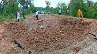 Onlookers stand at the site of an attack along a road in Dantewada district of Chhattisgarh. (AFP) Onlookers stand at the site of an attack along a road in Dantewada district of Chhattisgarh. (AFP)