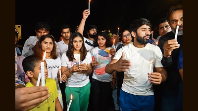 Wrestlers Bajrang Punia, Vinesh Phogat, Sakshi Malik and others take part in a candlelight march during their protest against the Wrestling Federation of India (WFI) chief Brij Bhushan Singh, Jantar Mantar, New Delhi, on Wednesday (ANI) Wrestlers Bajrang Punia, Vinesh Phogat, Sakshi Malik and others take part in a candlelight march during their protest against the Wrestling Federation of India (WFI) chief Brij Bhushan Singh, Jantar Mantar, New Delhi, on Wednesday (ANI)