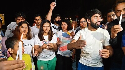 Wrestlers Bajrang Punia, Vinesh Phogat, Sakshi Malik and others take part in a candlelight march during their protest against the WFI chief and BJP MP Brij Bhushan Singh, Jantar Mantar, New Delhi. Wrestlers Bajrang Punia, Vinesh Phogat, Sakshi Malik and others take part in a candlelight march during their protest against the WFI chief and BJP MP Brij Bhushan Singh, Jantar Mantar, New Delhi.