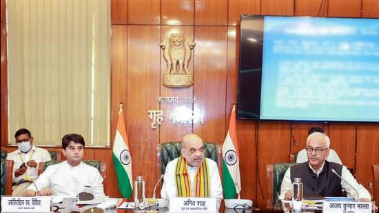Union ministers Jyotiraditya Scindia and Amit Shah during the review meeting, in New Delhi on Thursday. (ANI)