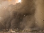 Debris flies from the direction of the launch pad as SpaceX's Starship launches from Starbase in Boca Chica, Texas