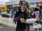 Fuminori Tsuchiko, 75-year-old humanitarian volunteer from Japan, looks through a window of his cafe, amid Russia's attack on Ukraine, in Kharkiv, Ukraine April 24. 