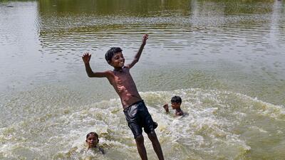Children bathe in a pond to beat the heat during a hot summer day, in Dharmanagar. (PTI) Children bathe in a pond to beat the heat during a hot summer day, in Dharmanagar. (PTI)