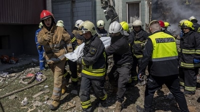 Firefighters carry a body recovered from the rubble of a residential building that was hit during a Russian attack in Uman, central Ukraine, Friday, April 28. (AP) Firefighters carry a body recovered from the rubble of a residential building that was hit during a Russian attack in Uman, central Ukraine, Friday, April 28. (AP)