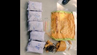 The five packets of heroin, weighing a total of 8kg, that were recovered from a field on the outskirts of Kakkar village in Punjab’s border district of Amritsar on Friday. (HT Photo)
