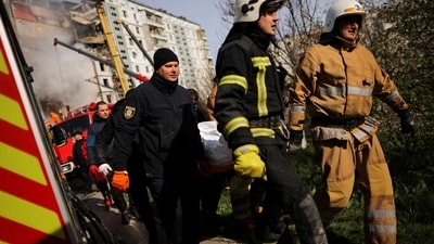 Russia-Ukraine War: Rescuers carry a body as they work at the site of a heavily damaged residential building hit by a Russian missile, amid Russia's attack on Ukraine. (Reuters)