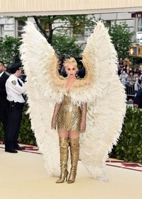 At the 2018 Met Gala, Katy Perry embraced the event's "Heavenly Bodies" theme with a gold Versace minidress. (Pinterest) At the 2018 Met Gala, Katy Perry embraced the event's "Heavenly Bodies" theme with a gold Versace minidress. (Pinterest)