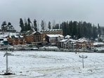 The tourist resort of Gulmarg and other mountainous areas were covered with overnight snowfall and widespread rains lashed the plains.