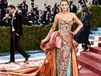 Blake Lively at the Met Gala 2022 red carpet in a rose gold metallic gown by Versace. (AFP)