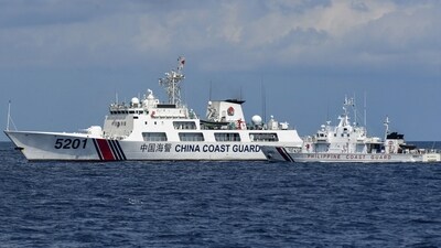 This photo taken on April 23, 2023 shows the Philippine coast guard vessel BRP Malapascua (R) manoeuvering as a Chinese coast guard ship cuts its path at Second Thomas Shoal in the Spratly Islands in the disputed South China Sea. (AFP) This photo taken on April 23, 2023 shows the Philippine coast guard vessel BRP Malapascua (R) manoeuvering as a Chinese coast guard ship cuts its path at Second Thomas Shoal in the Spratly Islands in the disputed South China Sea. (AFP)