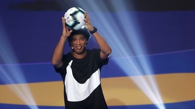 FILE - Brazil's Ronaldinho Gaucho shows the official ball during the draw for the 2019 Copa America soccer tournament in Rio de Janeiro, Brazil, Thursday, Jan. 24, 2019. Brazil great Ronaldinho is launching a worldwide street soccer league to give talented young players an opportunity to showcase their skills and follow the same path to stardom as the former Barcelona player. (AP Photo/Andre Penner, File) (AP) FILE - Brazil's Ronaldinho Gaucho shows the official ball during the draw for the 2019 Copa America soccer tournament in Rio de Janeiro, Brazil, Thursday, Jan. 24, 2019. Brazil great Ronaldinho is launching a worldwide street soccer league to give talented young players an opportunity to showcase their skills and follow the same path to stardom as the former Barcelona player. (AP Photo/Andre Penner, File) (AP)