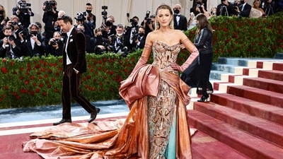 Blake Lively at the Met Gala 2022 red carpet in a rose gold metallic gown by Versace. (AFP)