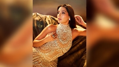Nora Fatehi completed her look with middle-parted straight hair, big diamond studs, silver stacked rings, and silver stiletto heels. Her flawless style and confidence set a new standard for red carpet fashion. (Instagram/@norafatehi ) Nora Fatehi completed her look with middle-parted straight hair, big diamond studs, silver stacked rings, and silver stiletto heels. Her flawless style and confidence set a new standard for red carpet fashion. (Instagram/@norafatehi )
