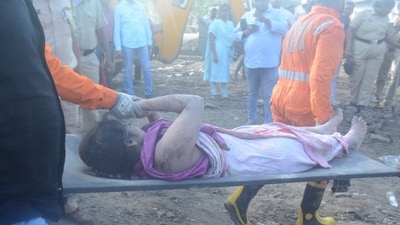 A trapped woman being carried to safety at the accident site. (Praful Gangurde/ Hindustan Times) A trapped woman being carried to safety at the accident site. (Praful Gangurde/ Hindustan Times)