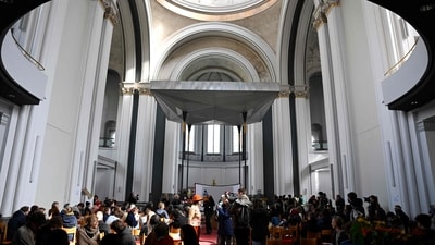 Activists of the environmental group "Last Generation" (Letzte Generation) are pictured during a Brunch inside the Saint Thomas church in Berlin�s Kreuzberg district on April 26. (AFP) Activists of the environmental group "Last Generation" (Letzte Generation) are pictured during a Brunch inside the Saint Thomas church in Berlin�s Kreuzberg district on April 26. (AFP)