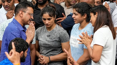 Delhi CM Arvind Kejriwal with wrestlers Vinesh Phogat, Sakshi Malik and Sangita Phogat during their protest at Jantar Mantar (PTI) Delhi CM Arvind Kejriwal with wrestlers Vinesh Phogat, Sakshi Malik and Sangita Phogat during their protest at Jantar Mantar (PTI)