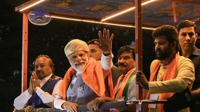 Prime Minister Narendra Modi waves at supporters during a roadshow ahead of the Karnataka assembly elections, in Mysuru, on Sunday. (PTI)