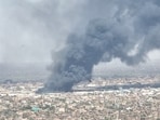 Drone footage shows birds in the foreground as clouds of black smoke billow over Bahri, also known as Khartoum North, Sudan on Monday.