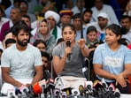 Wrestlers Bajrang Punia, Vinesh Phogat and Sakshi Malik speak with the media during their protest at Jantar Mantar, in New Delhi, Saturday, April 29, 2023.