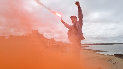 A protestor lights a flare during a demonstration on May Day (Labour Day), to mark the international day of workers in Saint-Malo, northwestern France, on May 1. (Jean-Francois Monier / AFP) A protestor lights a flare during a demonstration on May Day (Labour Day), to mark the international day of workers in Saint-Malo, northwestern France, on May 1. (Jean-Francois Monier / AFP)
