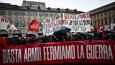 Protestors hold a banner reading "Stop Weapons, Stop War" in Piazza San Carlo during a demonstration on May Day (Labour Day), (Marco Bertorello / AFP) Protestors hold a banner reading "Stop Weapons, Stop War" in Piazza San Carlo during a demonstration on May Day (Labour Day), (Marco Bertorello / AFP)