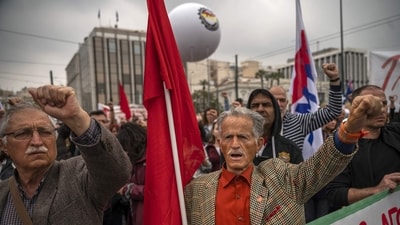 Members of the Greek communist labour union (PAME) protest during the May Day celebrations in central Athens. (Angelos Tzortzinis / AFP) Members of the Greek communist labour union (PAME) protest during the May Day celebrations in central Athens. (Angelos Tzortzinis / AFP)