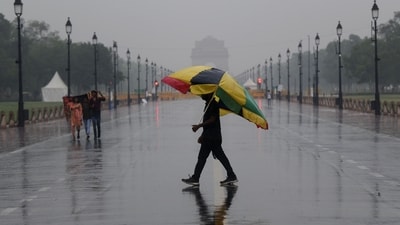 People walking at Kartavya Path amid rainfall at India Gate, in New Delhi on Monday. (ANI) People walking at Kartavya Path amid rainfall at India Gate, in New Delhi on Monday. (ANI)