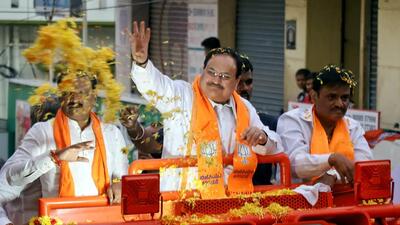 BJP chief JP Nadda waves at supporters during a roadshow ahead of Karnataka assembly elections in Bengaluru on Monday. (PTI) BJP chief JP Nadda waves at supporters during a roadshow ahead of Karnataka assembly elections in Bengaluru on Monday. (PTI)
