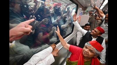 Samajwadi Party (SP) chief Akhilesh Yadav waves to the crowd while traveling in the Lucknow metro as part of the campaign for the Uttar Pradesh Urban Local Body Elections, in Lucknow on Monday. (ANI Photo)