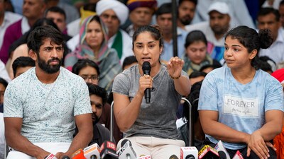 Wrestlers Bajrang Punia, Vinesh Phogat and Sakshi Malik speak with the media during their protest at Jantar Mantar, in New Delhi, Saturday, April 29, 2023. (PTI)