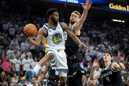 Sacramento Kings forward Domantas Sabonis (10) defends against Golden State Warriors forward Andrew Wiggins (22) who passes the ball during the second half of Game 7 of an NBA basketball first-round playoff series Sunday, April 30, 2023. (AP) Sacramento Kings forward Domantas Sabonis (10) defends against Golden State Warriors forward Andrew Wiggins (22) who passes the ball during the second half of Game 7 of an NBA basketball first-round playoff series Sunday, April 30, 2023. (AP)