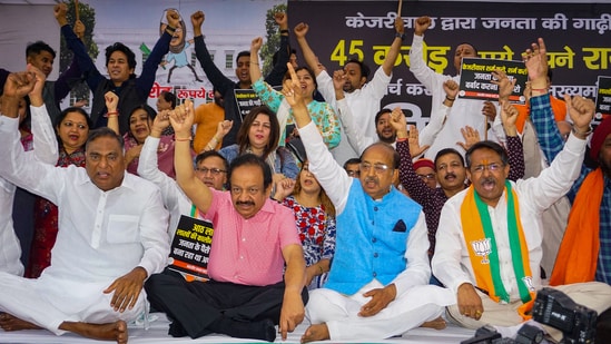 BJP MP Harsh Vardhan with party leaders Ramvir Singh Bidhuri and Vijay Goel raises slogans during a protest against Delhi Chief Minister Arvind Kejriwal, (PTI)