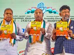 Congress president Mallikarjun Kharge with Karnataka Congress president DK Shivakumar and senior party leader Siddaramaiah in Bengaluru on Tuesday. (PTI)