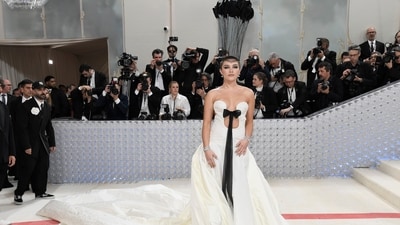 Florence Pugh attended the Met Gala in a white outfit. She also wore black headgear. The actor shaved her head. (AP) (Evan Agostini/Invision/AP) Florence Pugh attended the Met Gala in a white outfit. She also wore black headgear. The actor shaved her head. (AP) (Evan Agostini/Invision/AP)