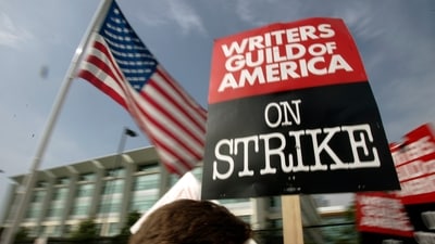 Writers Guild of America (WGA) writers and others strike against the Alliance of Motion Picture and Television Producers (AMPTP) in a rally at Fox Plaza in Los Angeles' Century City district. (AP) Writers Guild of America (WGA) writers and others strike against the Alliance of Motion Picture and Television Producers (AMPTP) in a rally at Fox Plaza in Los Angeles' Century City district. (AP)