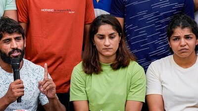 Wrestlers Bajrang Punia, Vinesh Phogat and Sakshi Malik address the media during their protest at Jantar Mantar (PTI) Wrestlers Bajrang Punia, Vinesh Phogat and Sakshi Malik address the media during their protest at Jantar Mantar (PTI)
