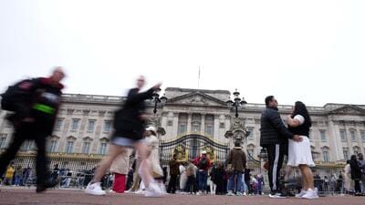 Tourists visit Buckingham Palace in London on Tuesday. The coronation of King Charles III will takes place at Westminster Abbey on May 6. (AP)
