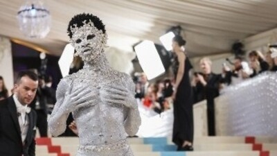 Lil Nas X posed in silver body paint and a matching face mark decorated in silver embellishments. (Reuters) Lil Nas X posed in silver body paint and a matching face mark decorated in silver embellishments. (Reuters)