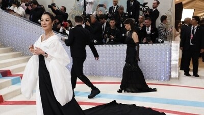 Michelle Yeoh paid homage to Karl Lagerfeld in a monochrome gown with a shirt-styled detail and a long black train. (Reuters) Michelle Yeoh paid homage to Karl Lagerfeld in a monochrome gown with a shirt-styled detail and a long black train. (Reuters)