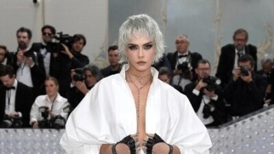 Cara Delevingne posed in a white shirt with a plunging neckline, teamed with a dramatic shrug, black leather stockings and a sleek neck chain, as she attended fashion's biggest night this year. (AP) Cara Delevingne posed in a white shirt with a plunging neckline, teamed with a dramatic shrug, black leather stockings and a sleek neck chain, as she attended fashion's biggest night this year. (AP)