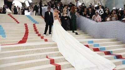 Florence Pugh posed for the red-carpet in a dramatic gown with a state,ent white train styled on the stairs. (Reuters) Florence Pugh posed for the red-carpet in a dramatic gown with a state,ent white train styled on the stairs. (Reuters)