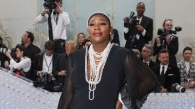 Serena Williams posed in a monochrome gown with black bodycon details, puffy lace sleeves, a lunging neckline, and white tulle frills at till the ankles. in multiple white neck chains, a white head gear and bright makeup, she aced the look. (Reuters) Serena Williams posed in a monochrome gown with black bodycon details, puffy lace sleeves, a lunging neckline, and white tulle frills at till the ankles. in multiple white neck chains, a white head gear and bright makeup, she aced the look. (Reuters)